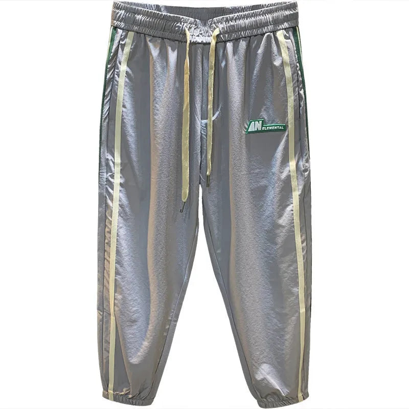 Men's solid black cotton harem trousers with a mid-waist and loose fit.