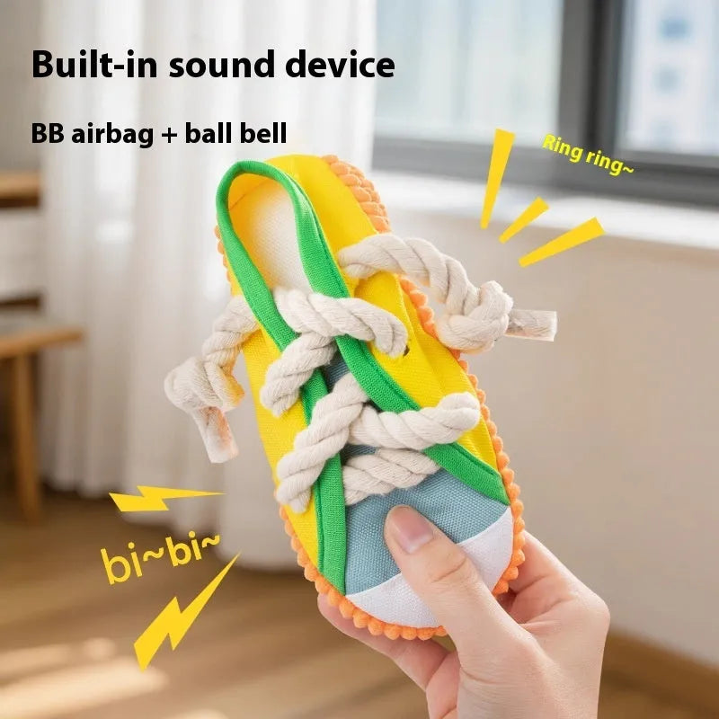 Yellow plastic dog chew toy shaped like slippers, with a sound mechanism for pet play.