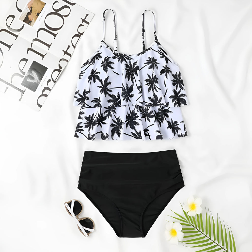 High waisted black floral print bikini with adjustable straps, shown on a model.