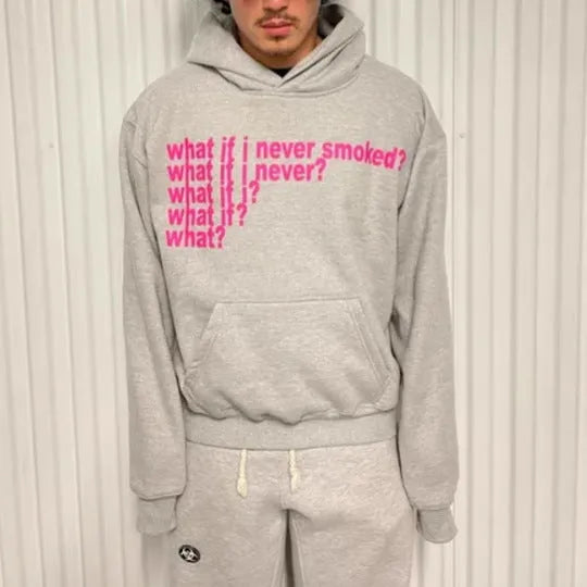 Black heavy hooded sweater with white letter print on chest, shown on a model.