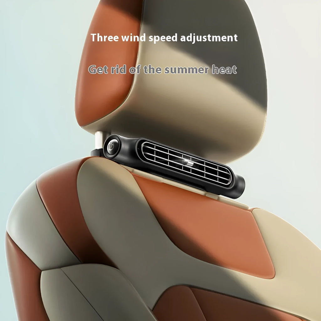 Compact black USB car fan with Velcro strap mounted on a car seat headrest.