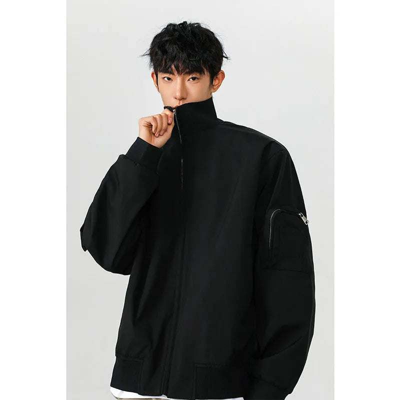 Men's large size multi-pocket short flight jacket in black, loose fit, polyester fiber fabric with visible pockets.