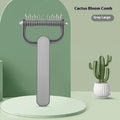 Green and grey dog detangling comb with stainless steel teeth on a PP plastic handle.