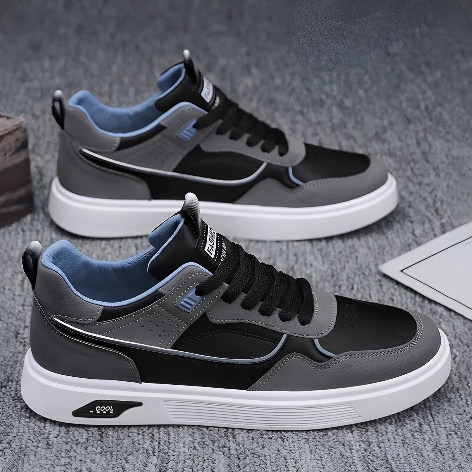 Men's low-top canvas board shoes in grey with leather stitching and mesh lining visible at the collar.