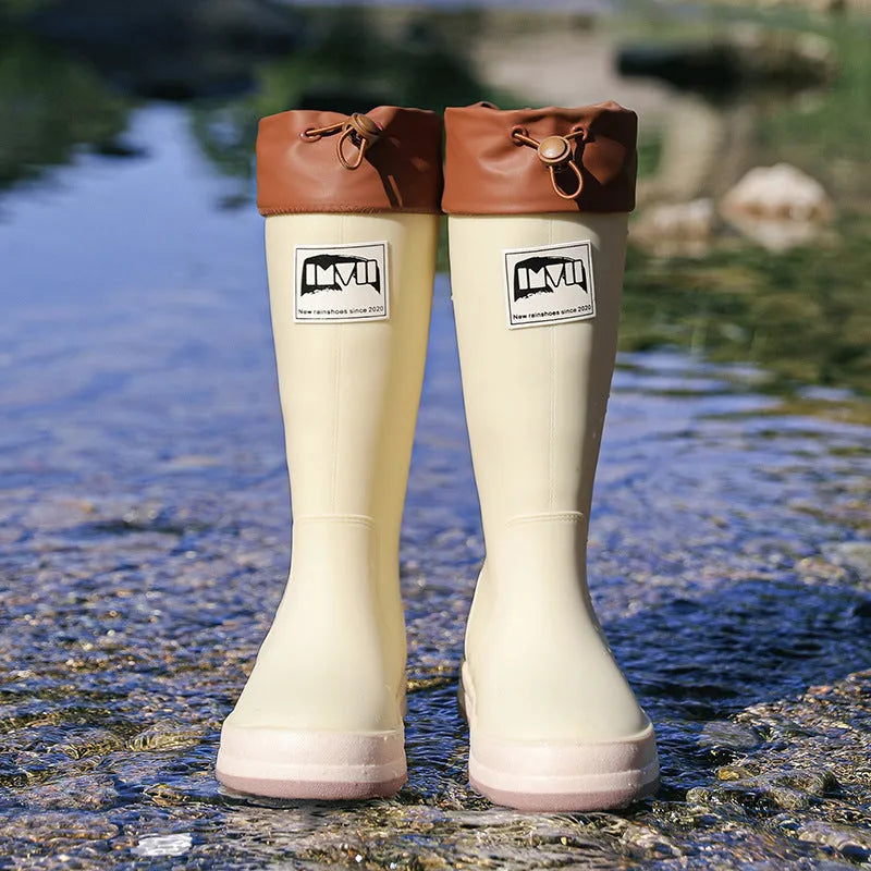 PVC waterproof high tube rain boots in beige, black, green, and red colours on a white background.