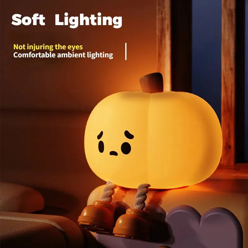 Soft orange silicone pumpkin-shaped night light with a warm glowing light.