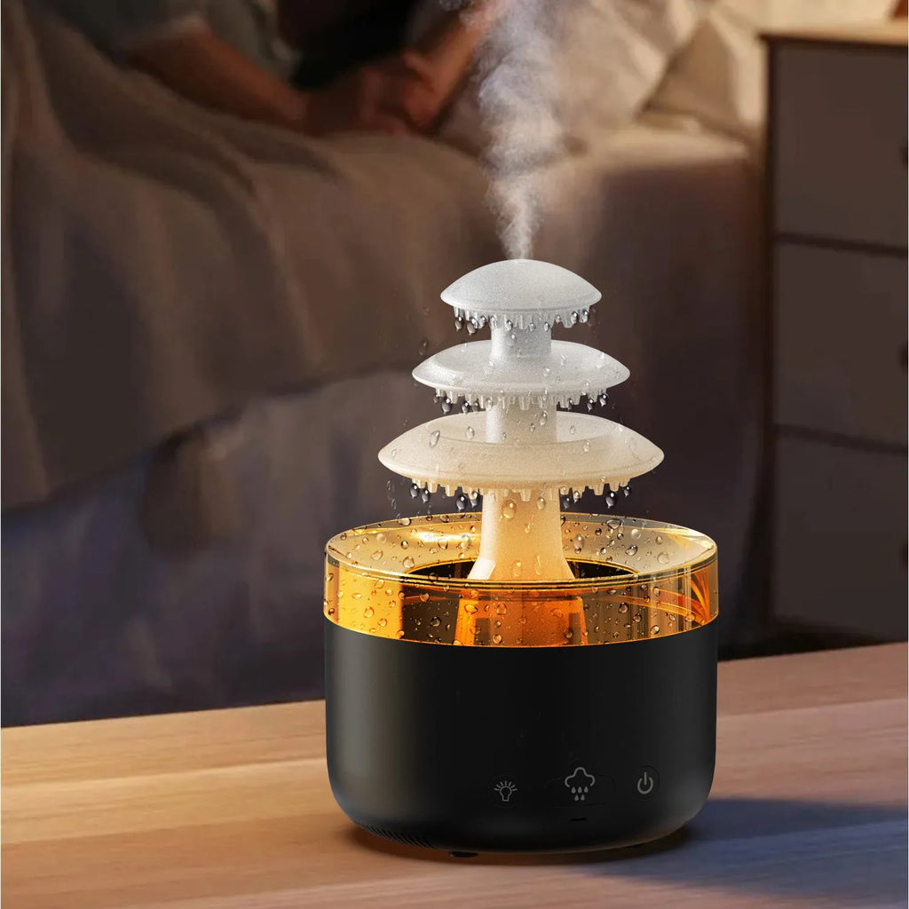 White Cloud Rain air humidifier and essential oil diffuser with colourful LED lights on a wooden table.