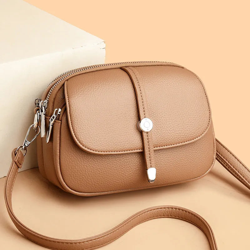 City Simple oval-shaped women's crossbody shoulder bag in khaki PU with sewing thread detail.