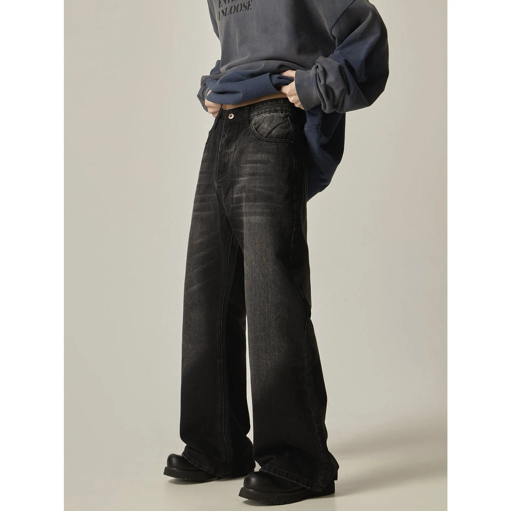 Black straight-leg jeans with retro styling and loose fit on man
