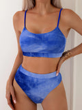Women's blue and orange tie-dye pleated split bikini made from polyester.