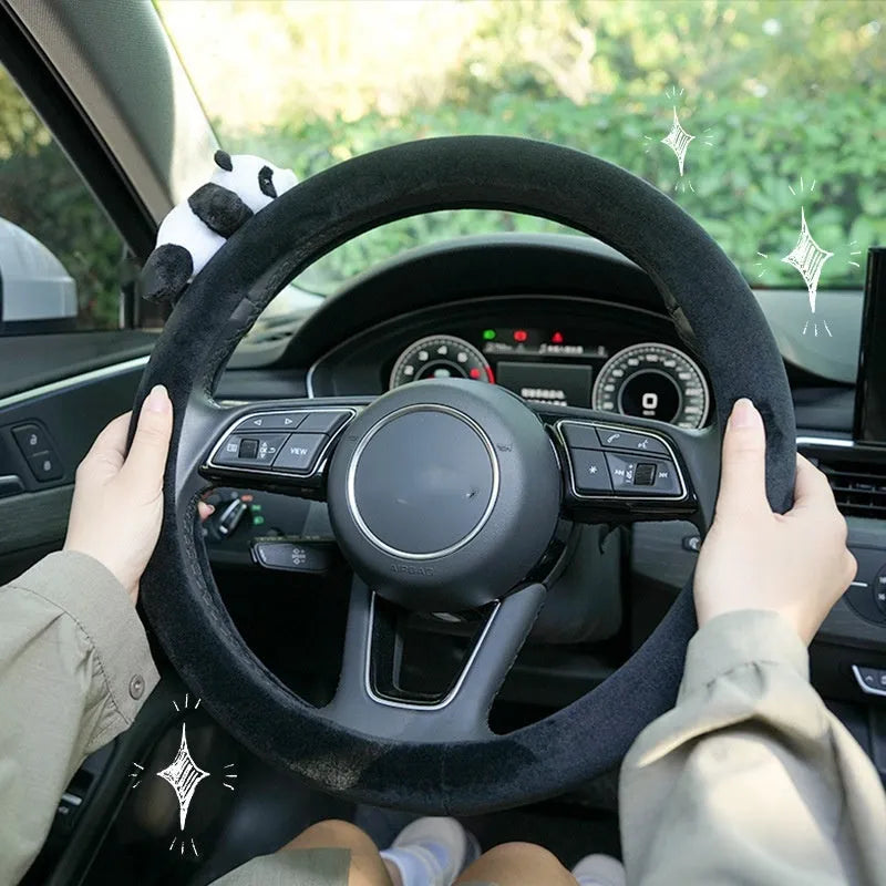 Plush black panda design steering wheel cover and matching shoulder pad set for cars.