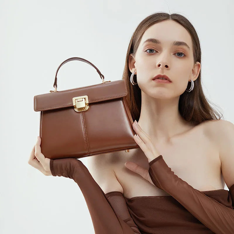 Black genuine leather women's shoulder bag with a front clasp, shown with a detailed view of the internal zip pocket.