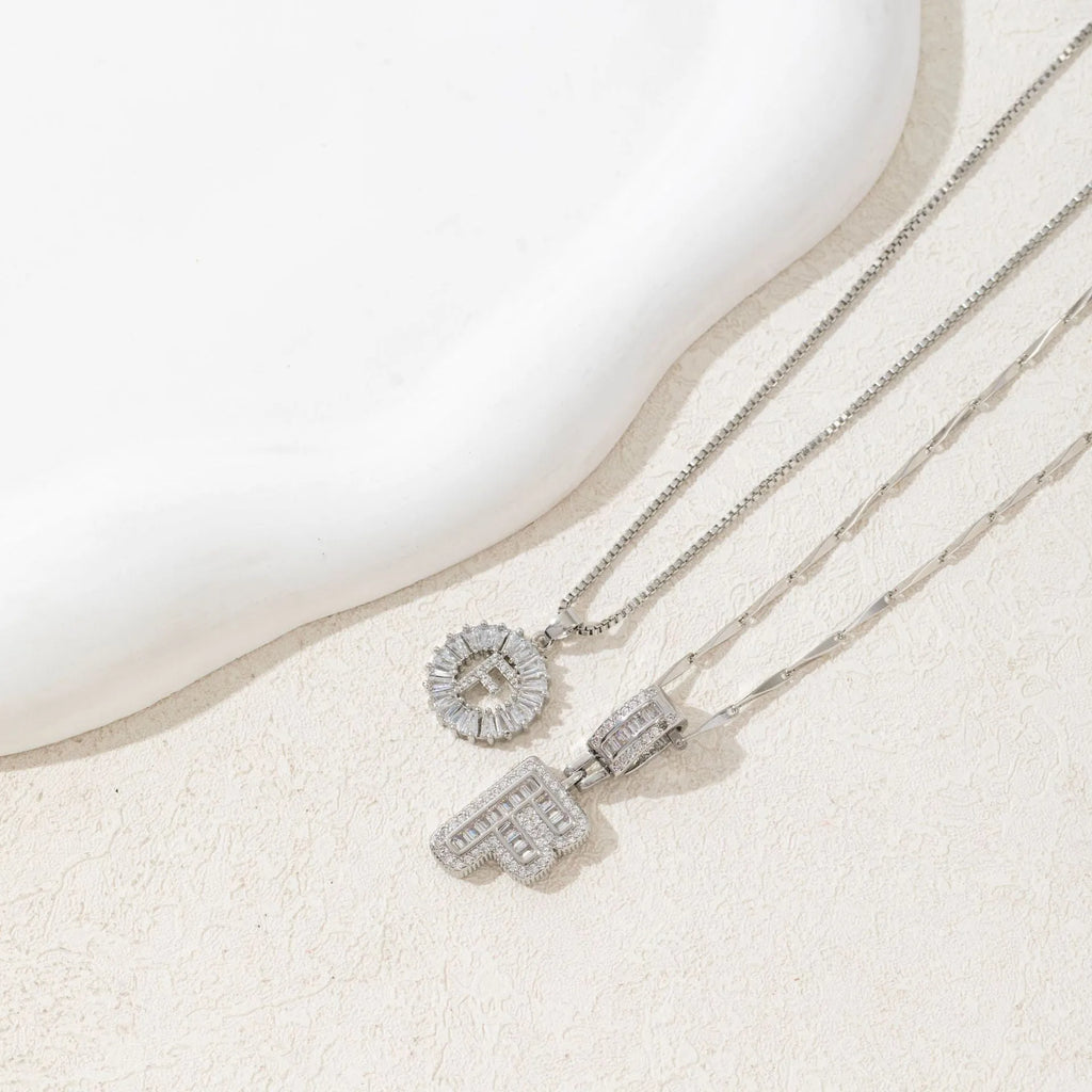 26 English letters copper-plated gold diamond initial pendant necklace with adjustable chain on display