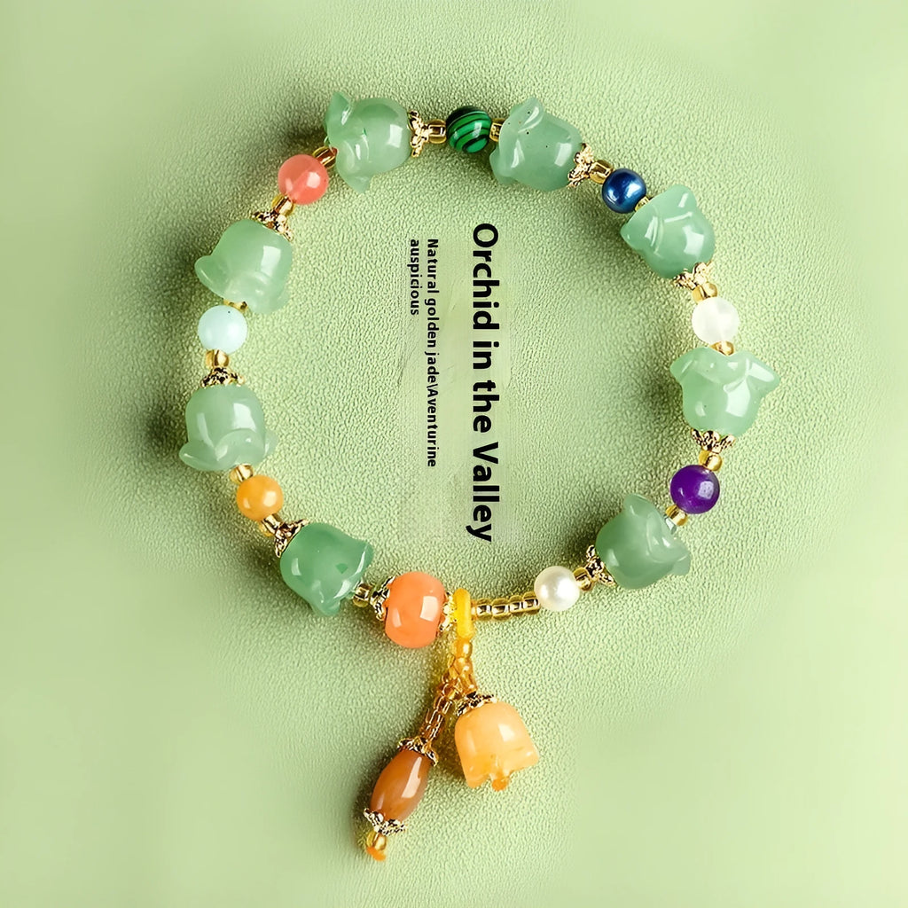 Natural Xinjiang Jinsi Jade bracelet with carved orchid beads in aventurine orchid colour.