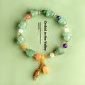 Natural Xinjiang Jinsi Jade bracelet with carved orchid beads in aventurine orchid colour.