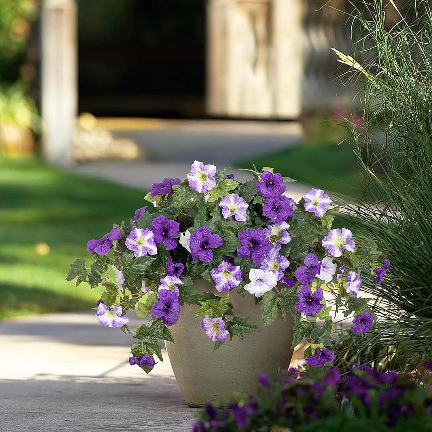 Purple plastic garden container with 12 forks holding red artificial silk flowers on a patio.