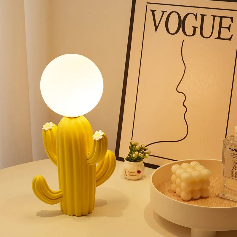 Green cactus button desk lamp with three-colour accents on a bedside table in a child's room