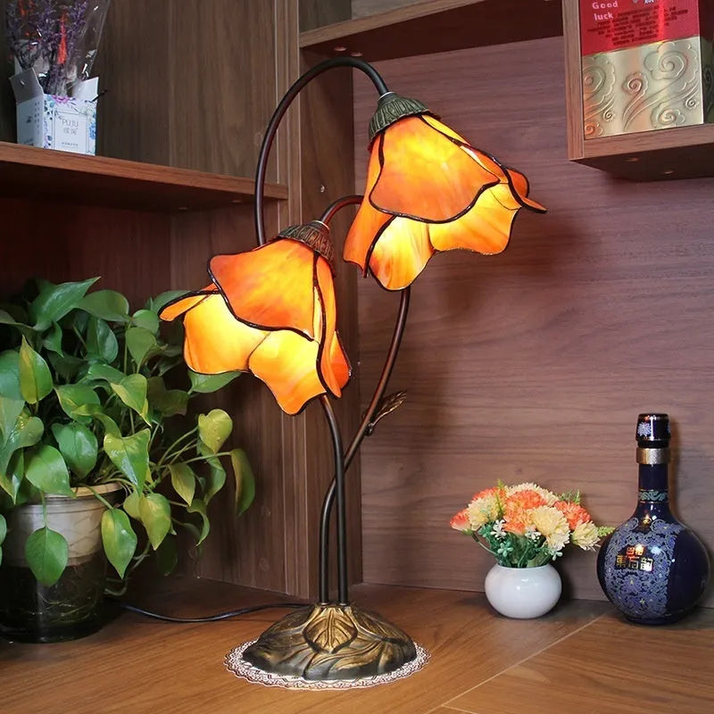 Retro American classical desk lamp with a decorative glass shade on a table.