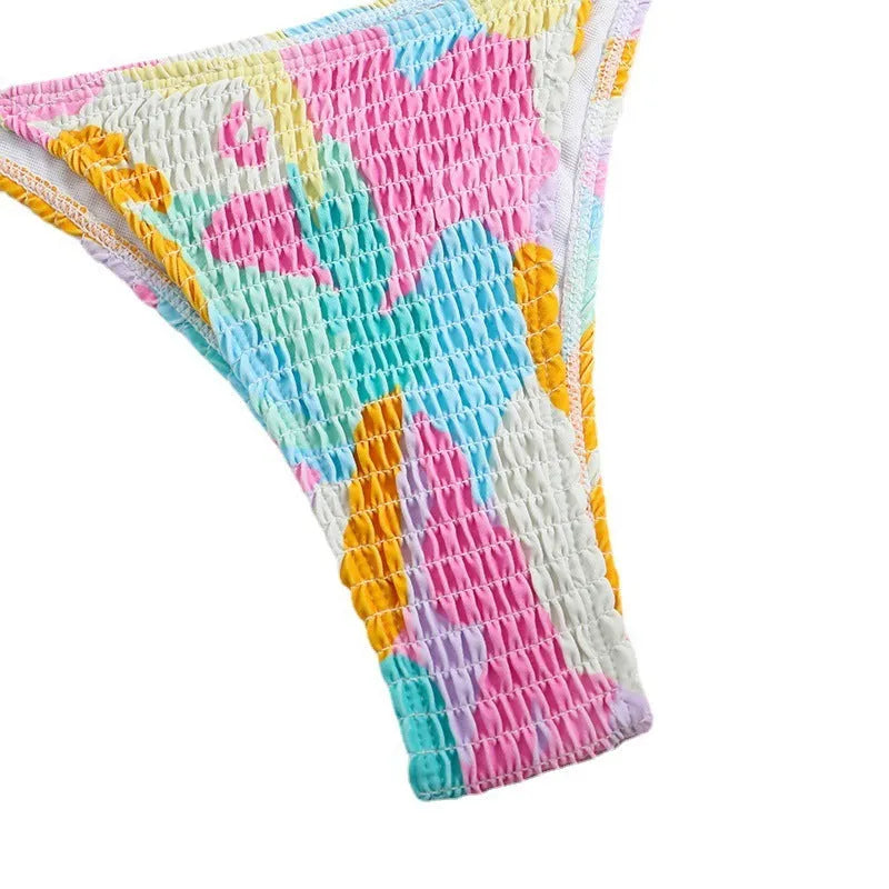 Women's triangle bag bikini swimsuit with printed floral gradient pattern and smocking detail