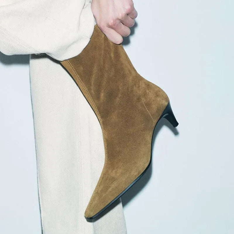 Brown square toe kitten heel mid-calf boots with side zipper on a wooden floor.