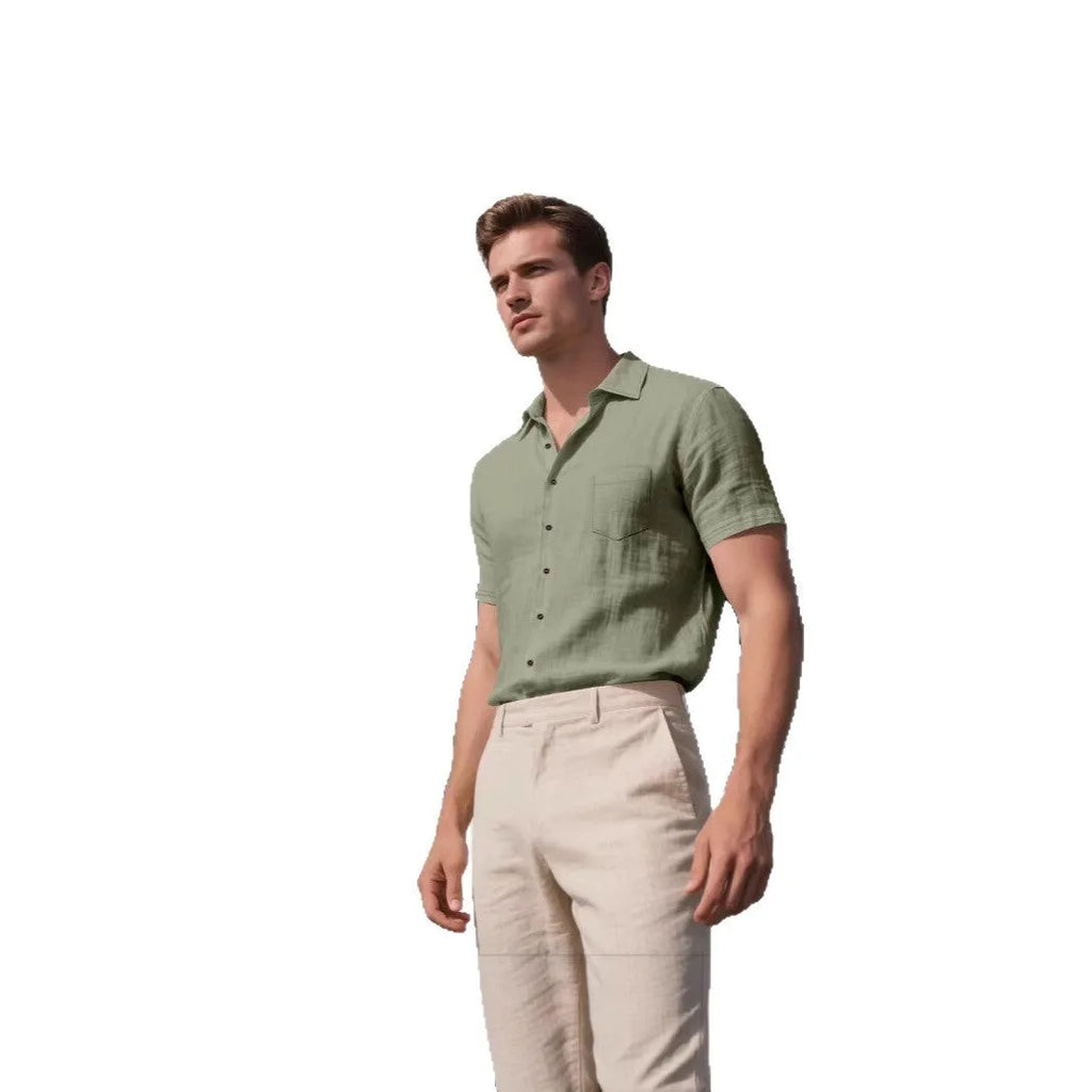 Man wearing a loose-fit grey short-sleeve linen blend shirt for casual leisure.