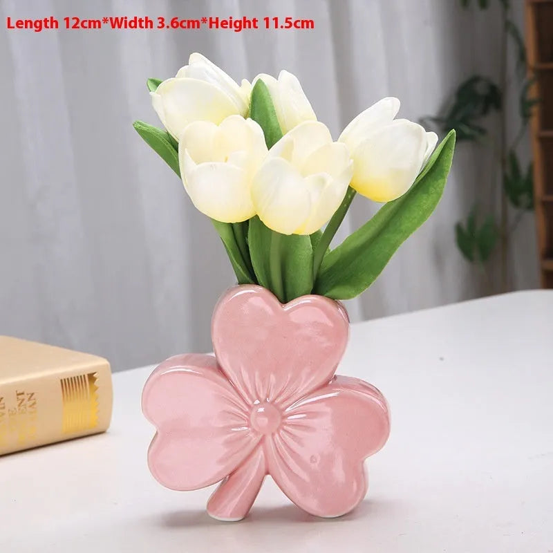 Clover white porcelain ceramic vase in European style on a desk.