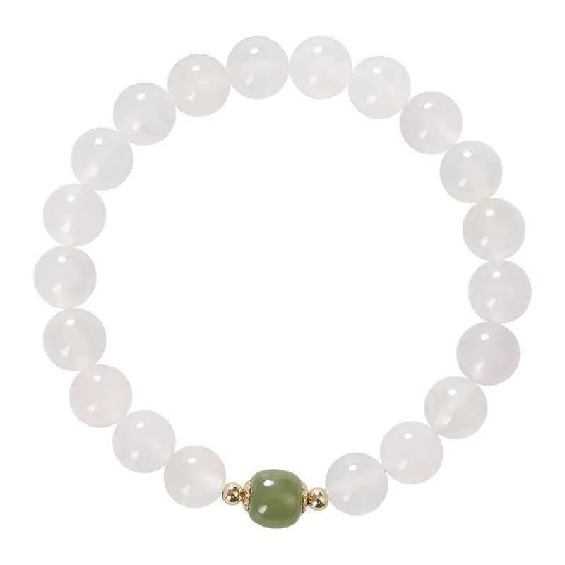 Handmade white agate and crystal bracelet with cinnabar inlay, showing text design on beads