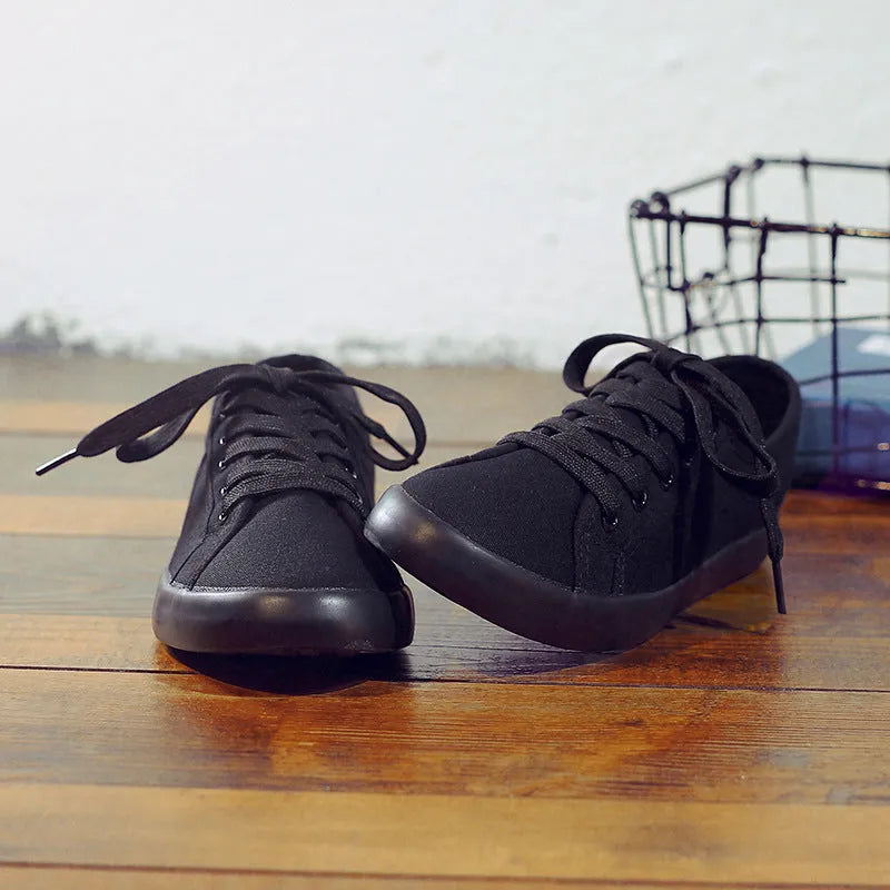 All-black women's canvas lace-up work shoes with flat rubber soles