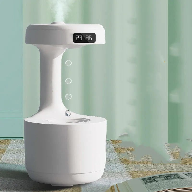 White columnar anti-gravity humidifier on a desk with LED clock display and visible mist.