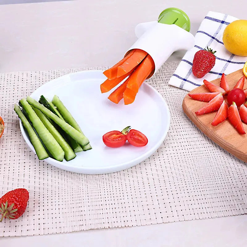 White handheld vegetable cutter with multiple stainless steel blades for slicing cucumbers, carrots, and strawberries.
