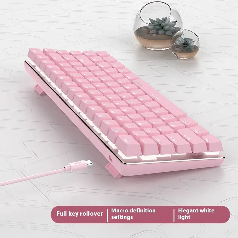 Pink mechanical gaming keyboard with 82 keys, white backlight, and metal construction on desk