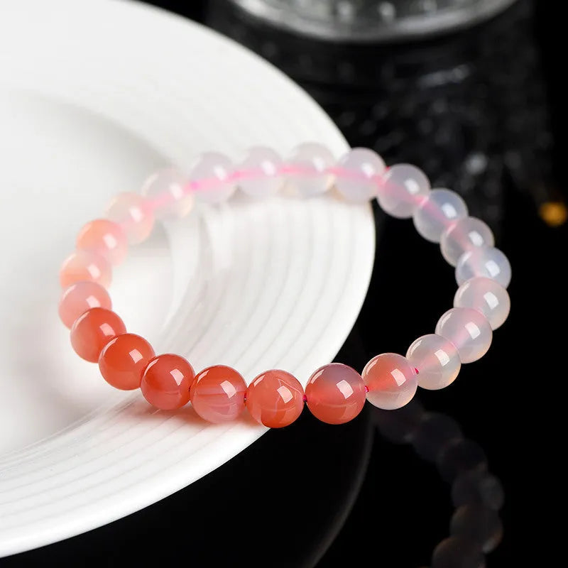 Yanyuan agate bracelet with gradient salt source coloured beads in a geometric shape on a wrist.