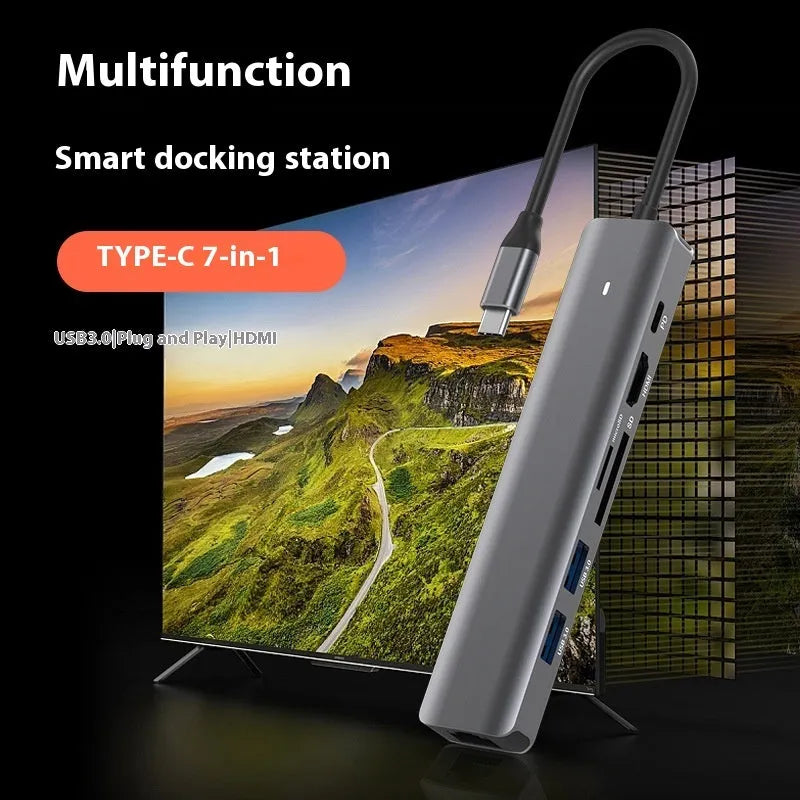 LQT-LH07 7-in-1 USB-C card reader and computer hub on a desk next to a laptop.