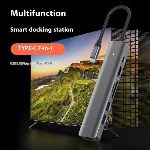 LQT-LH07 7-in-1 USB-C card reader and computer hub on a desk next to a laptop.