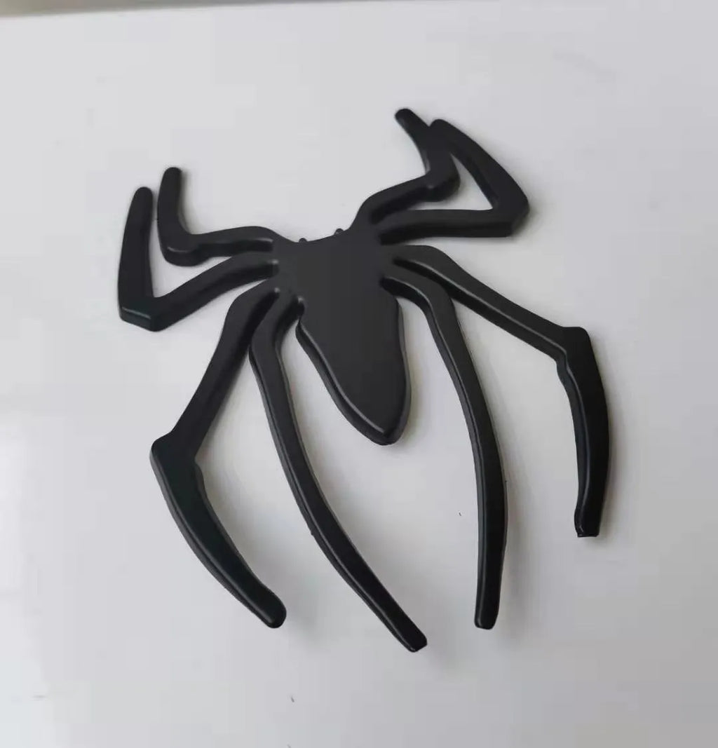 3D metal spider bumper sticker in gold on a car bumper