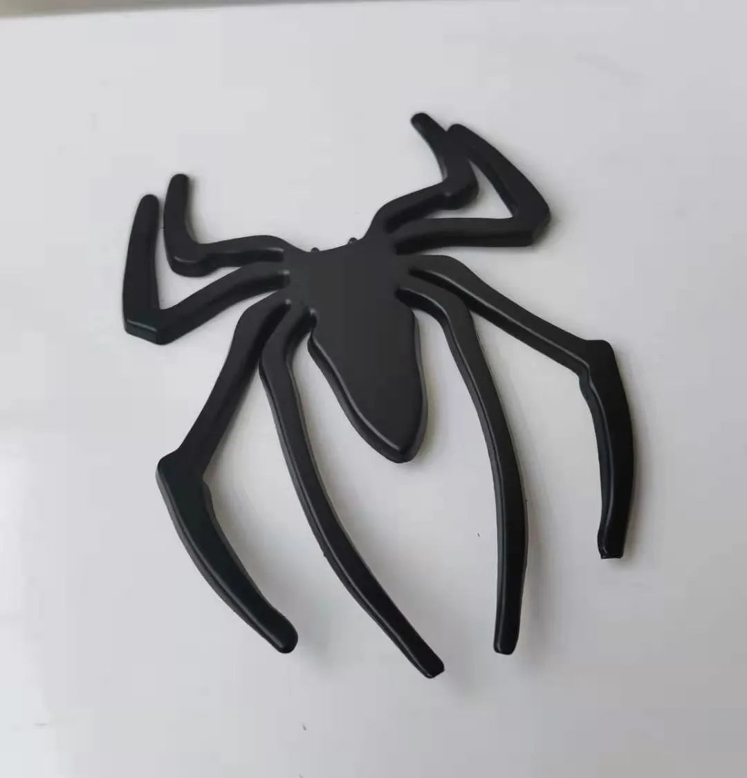 3D metal spider bumper sticker in gold on a car bumper