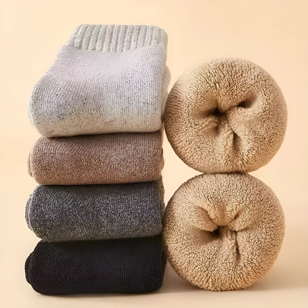 Pair of minimalist solid-colour wool socks showcasing the thick knitted merino wool midsole on the sole.