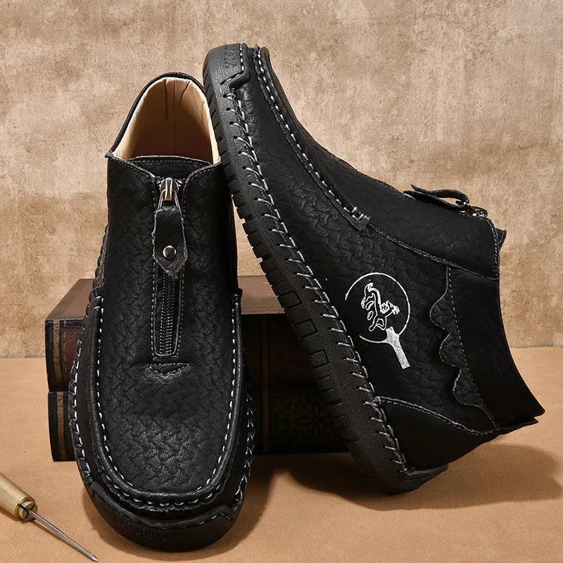 Men's black slip-on leather loafers with round toe and sewn sole on a rubber outsole.