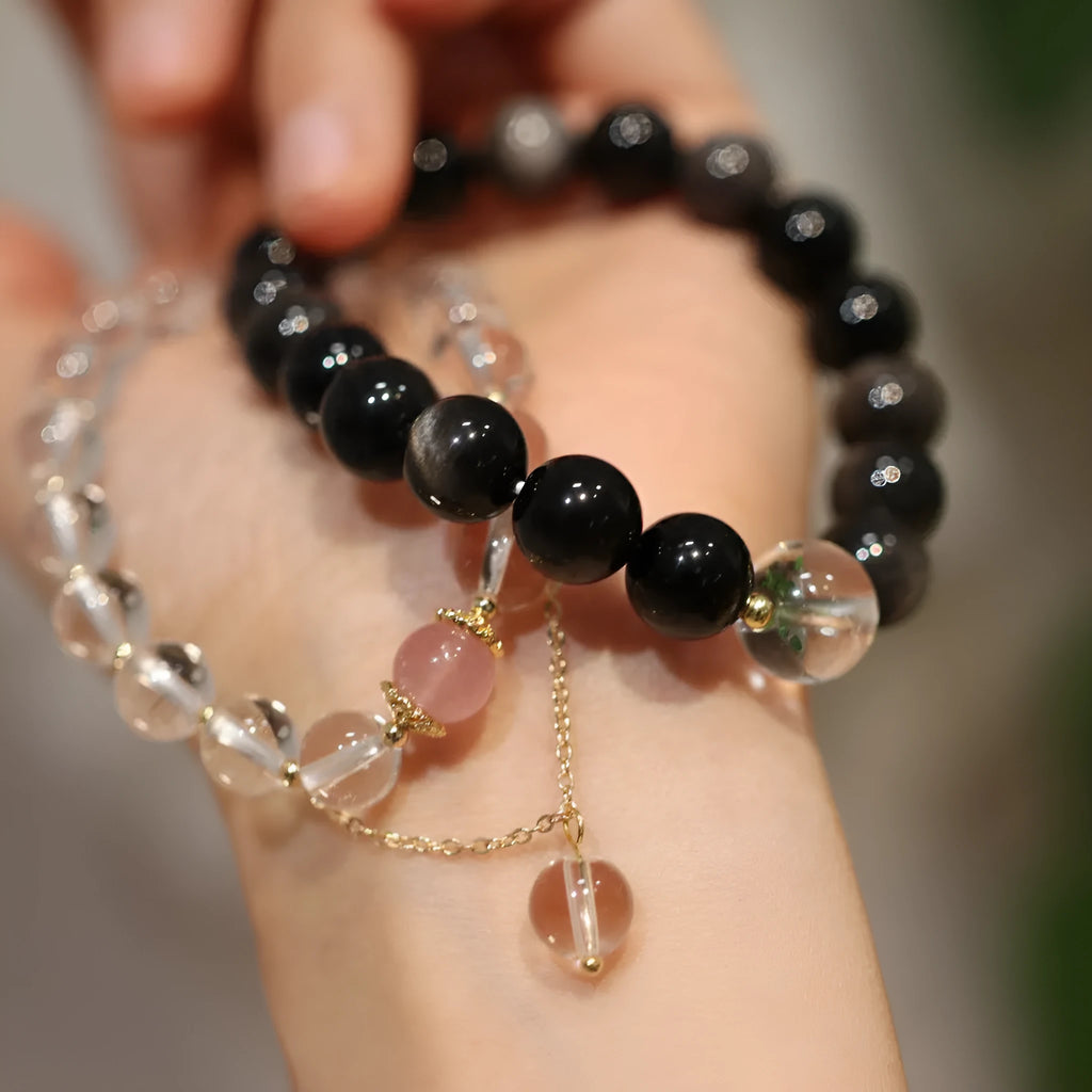White and pink crystal bracelet with geometric Chinese design and cat eye obsidian elements