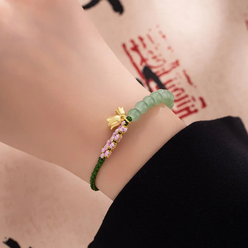 Hand woven red rope bracelet for women with lily carrying strap design and flower pattern
