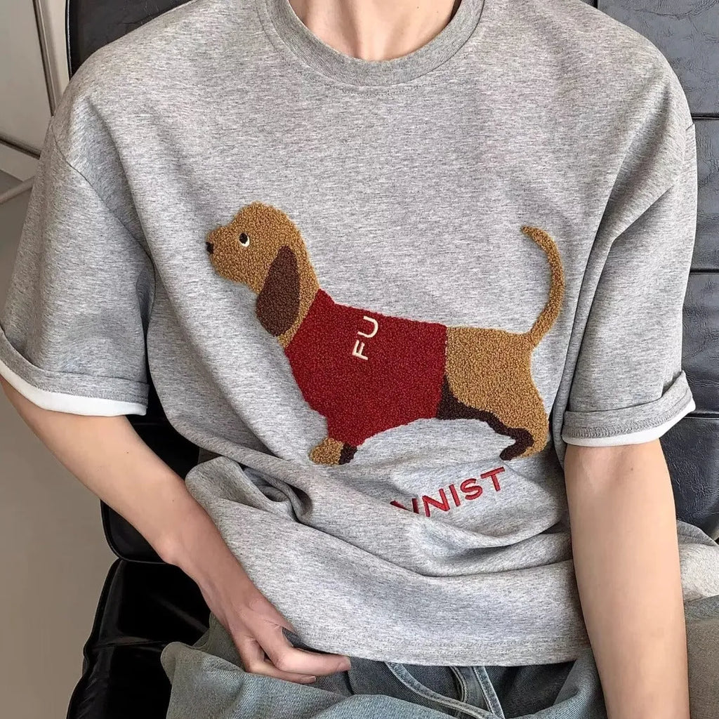 Men's grey cotton T-shirt with a black embroidered sausage dog design on the chest.