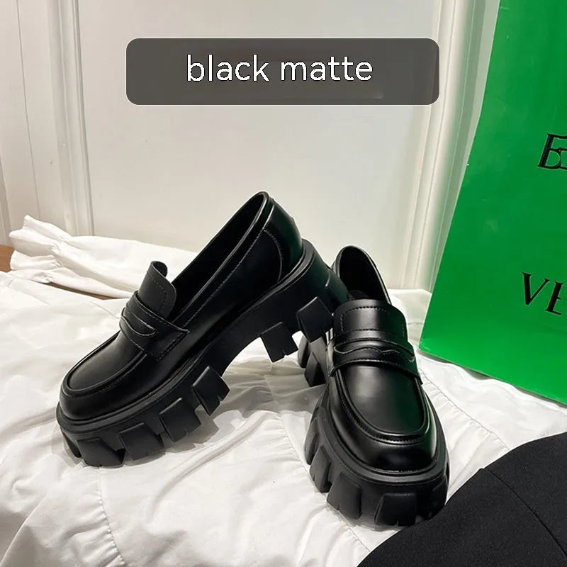 British style wide fit loafers in matte or patent leather with a rubber sole and muffin heel.