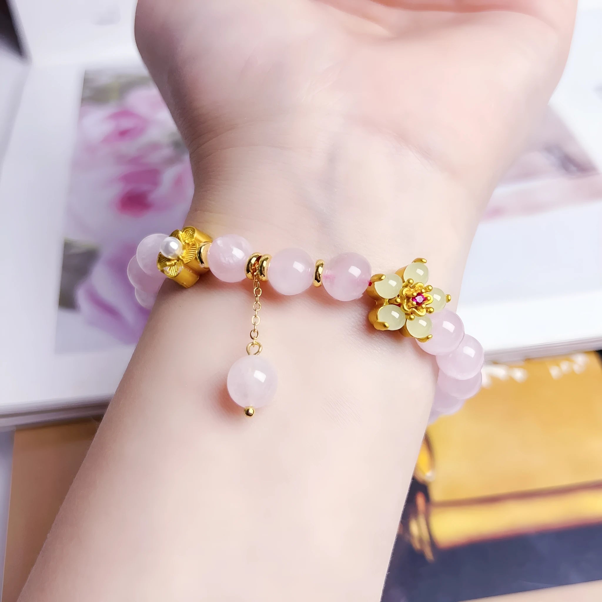 Pink crystal peach blossom bracelet with adjustable sliding knot closure on wrist