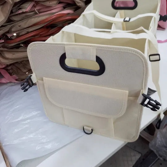 Foldable multi-compartment car boot storage box in black with handle and waterproof fabric construction