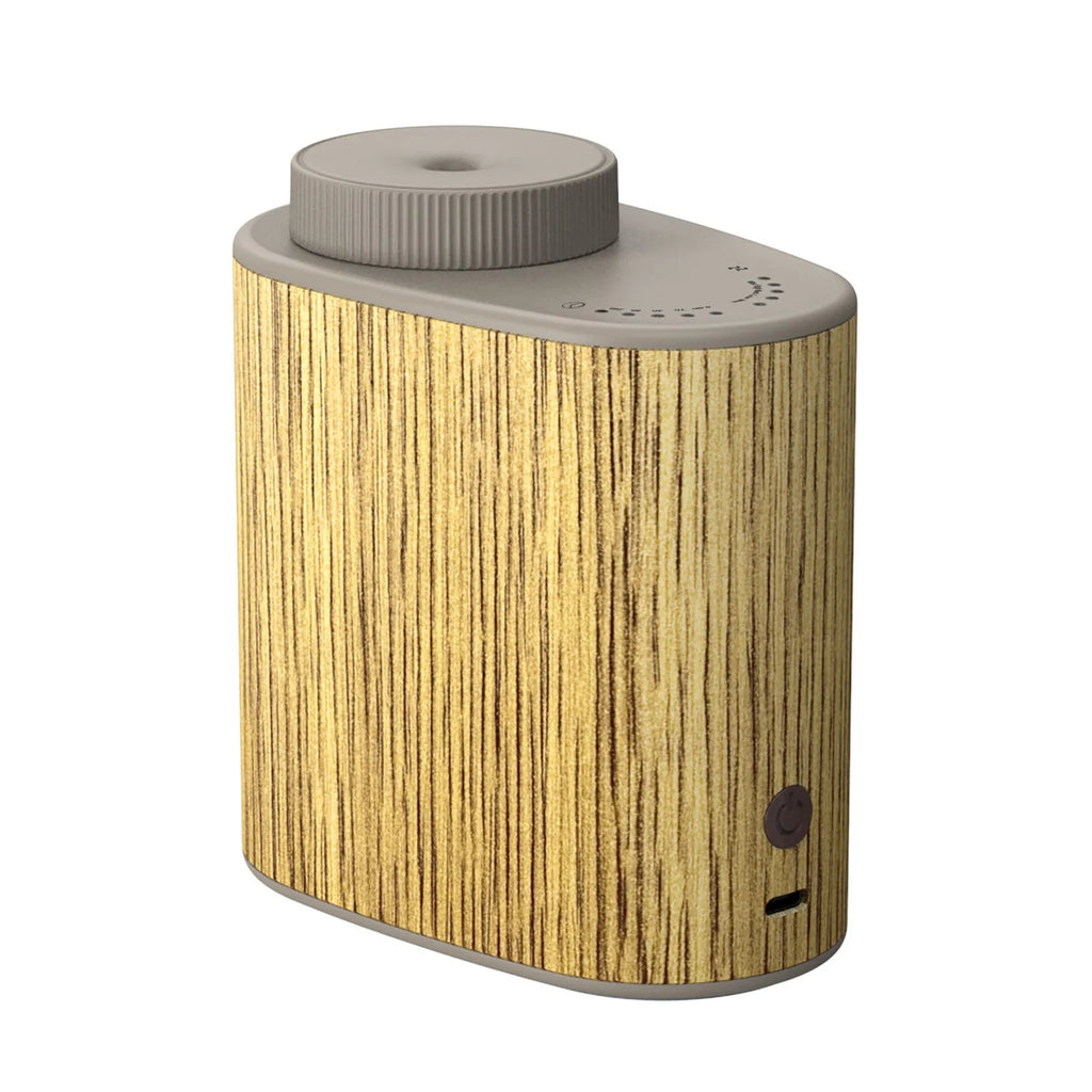 Round plug-in USB nebulizing diffuser in black wood texture with automatic aerosol dispenser and timing function