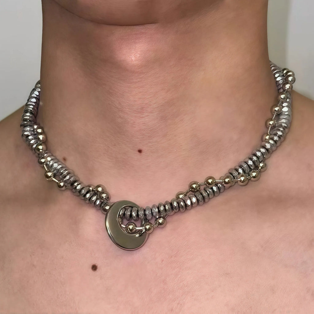 Silvery hand-woven titanium steel hip hop necklace with winding heavy industry chain texture on white background