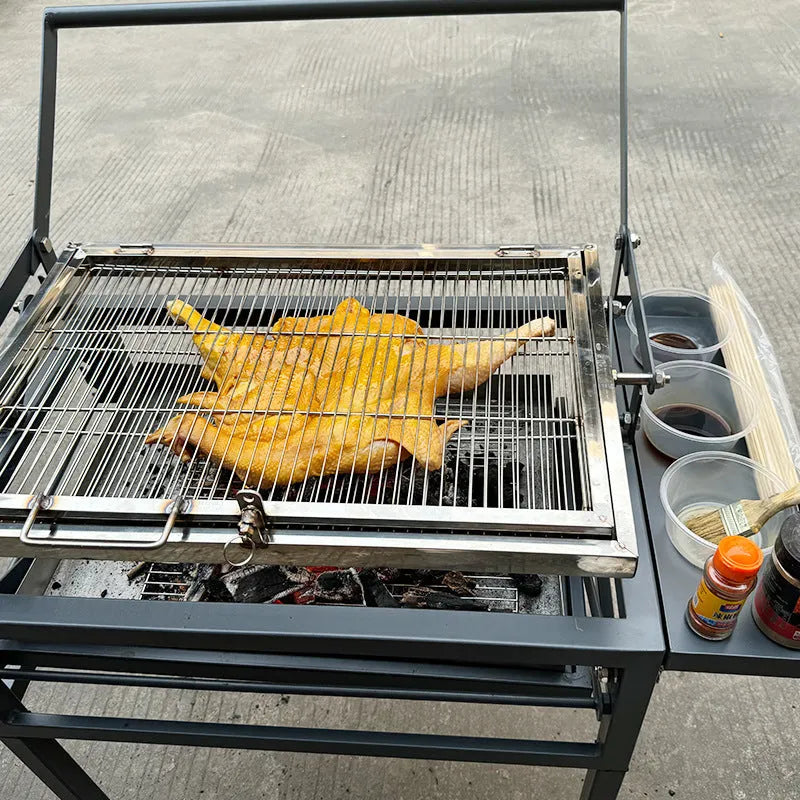 Large black stainless steel portable charcoal barbecue grill in a foldable design.