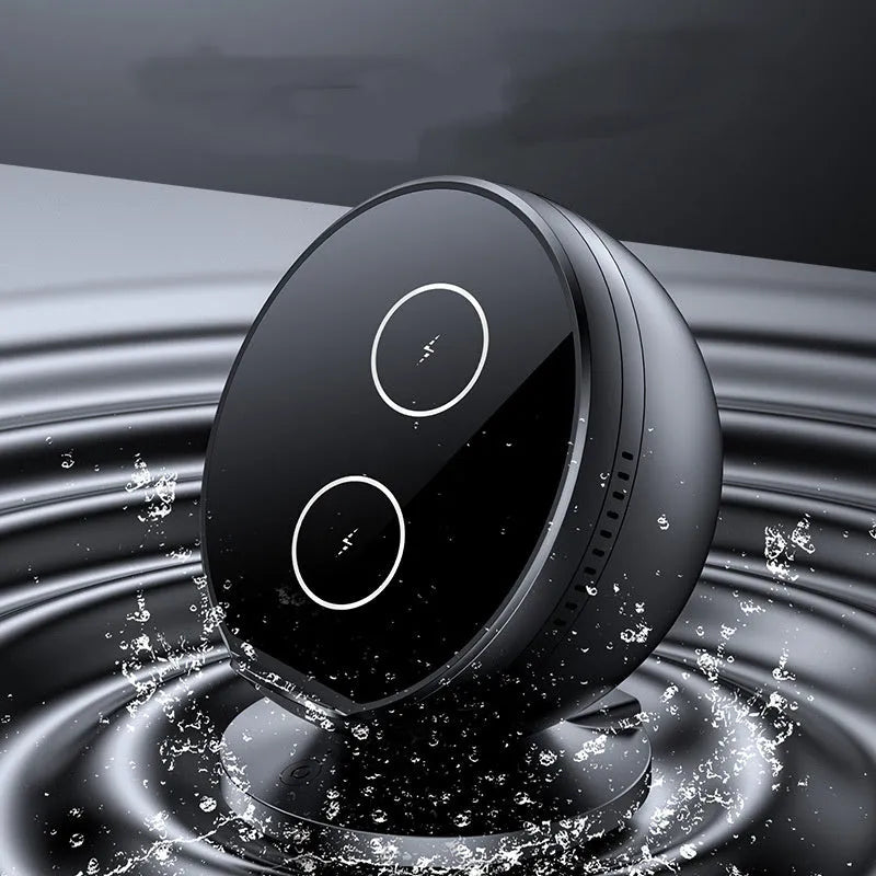 A black multifunctional mobile phone holder with integrated wireless charger and Bluetooth speaker on a desk.