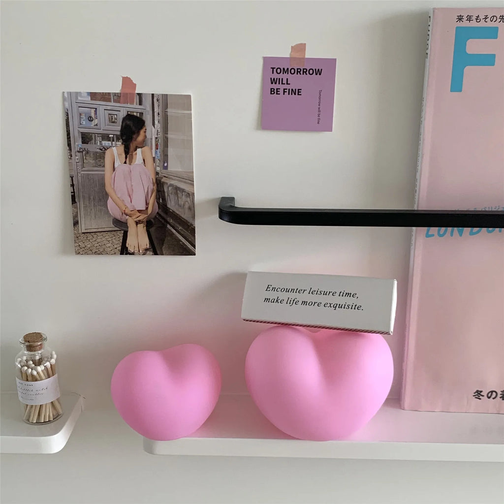 White and pink vinyl atmosphere lamps in small and large sizes with warm glowing light.