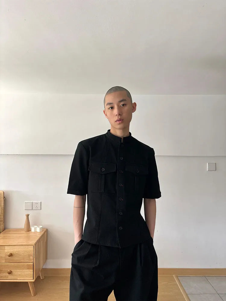 Handmade black loose fit half sleeve shirt with a shirt collar on a hanger.